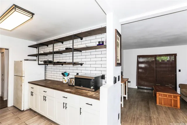 a kitchen with stainless steel appliances kitchen island granite countertop a stove and a sink