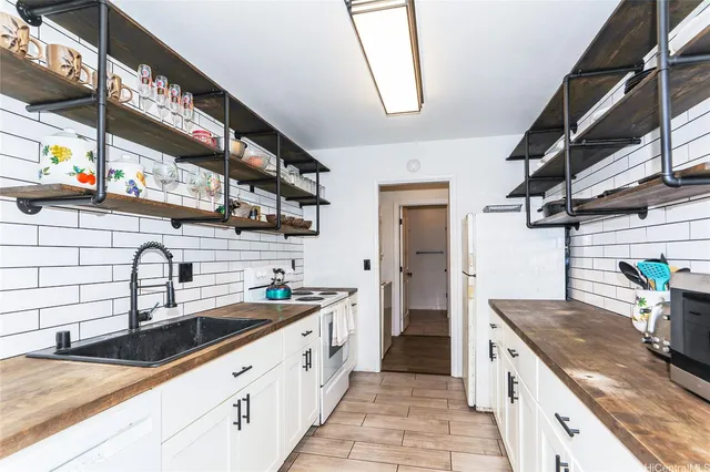 a kitchen with stainless steel appliances granite countertop a sink and a stove