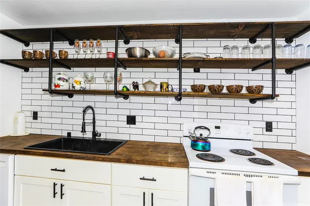 a kitchen with lots of counter top space and stainless steel appliances
