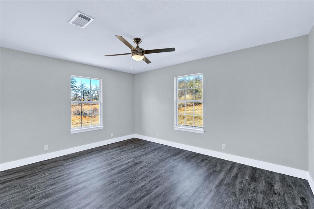 566 McCraw Lane Denison, TX 75021 - Photo 12 of 25 a view of an empty room with wooden floor and a window