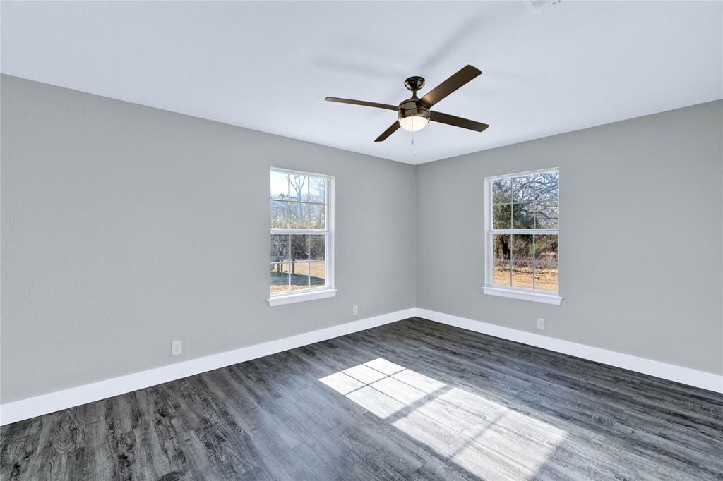 566 McCraw Lane Denison, TX 75021 - Photo 15 of 25 a view of empty room with wooden floor and fan