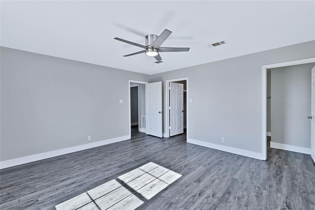566 McCraw Lane Denison, TX 75021 - Photo 19 of 25 a view of an empty room and window a ceiling fan and wooden floor