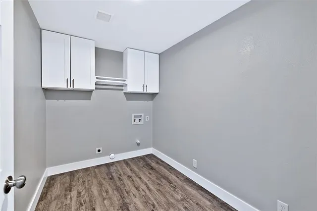 a view of a kitchen with white cabinets and a wooden floor