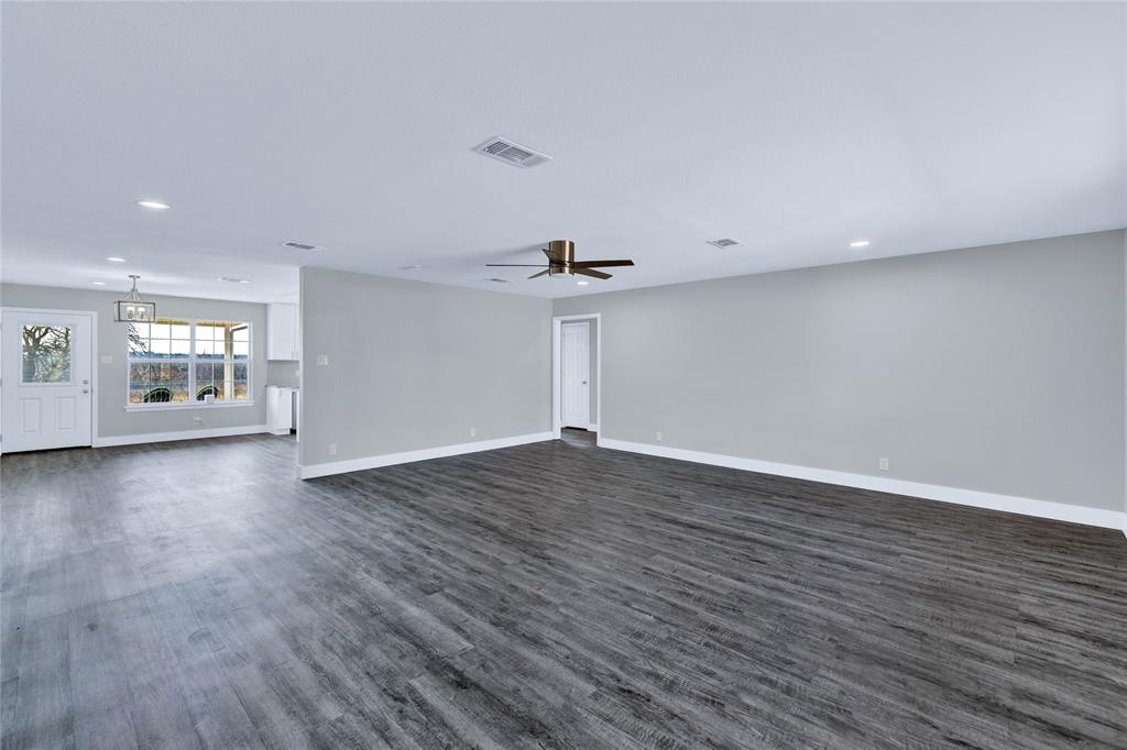 566 McCraw Lane Denison, TX 75021 - Photo 7 of 25 a view of empty room with wooden floor and window