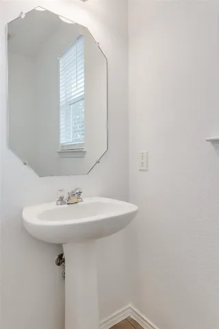 a bathroom with a sink a mirror and a window