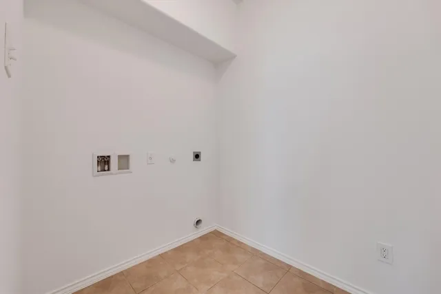 an empty room with closet and a ceiling fan