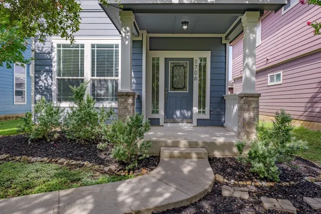a view of a brick house with plants