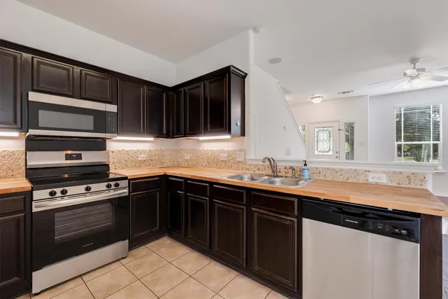 a kitchen with stainless steel appliances a stove sink and cabinets