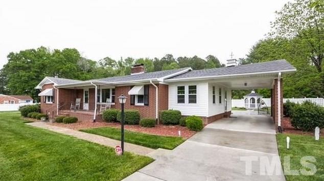 70 Spring Valley Road Henderson, NC 27537 - Photo 1 of 14 a view of a house with a yard and potted plants