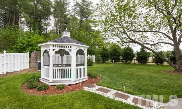 70 Spring Valley Road Henderson, NC 27537 - Photo 14 of 14 a view of a garden with a deck