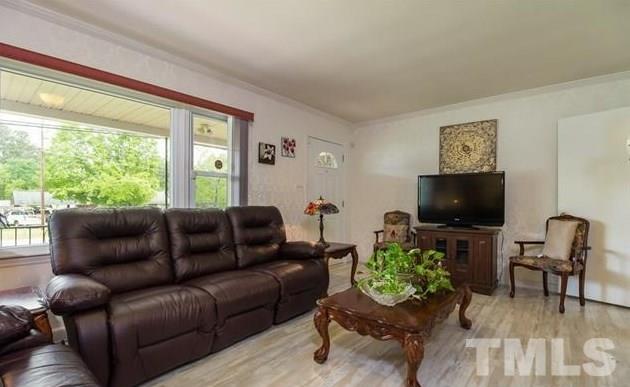 70 Spring Valley Road Henderson, NC 27537 - Photo 4 of 14 a living room with furniture and a flat screen tv