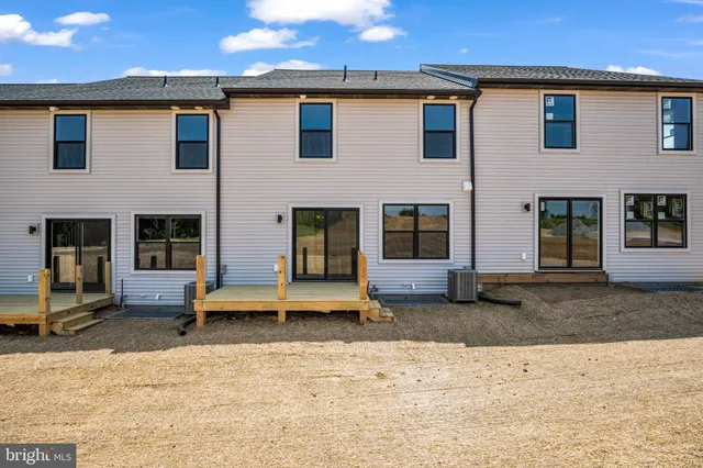 a backyard of a house with outdoor seating