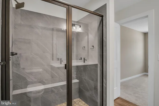 a bathroom with a glass shower door