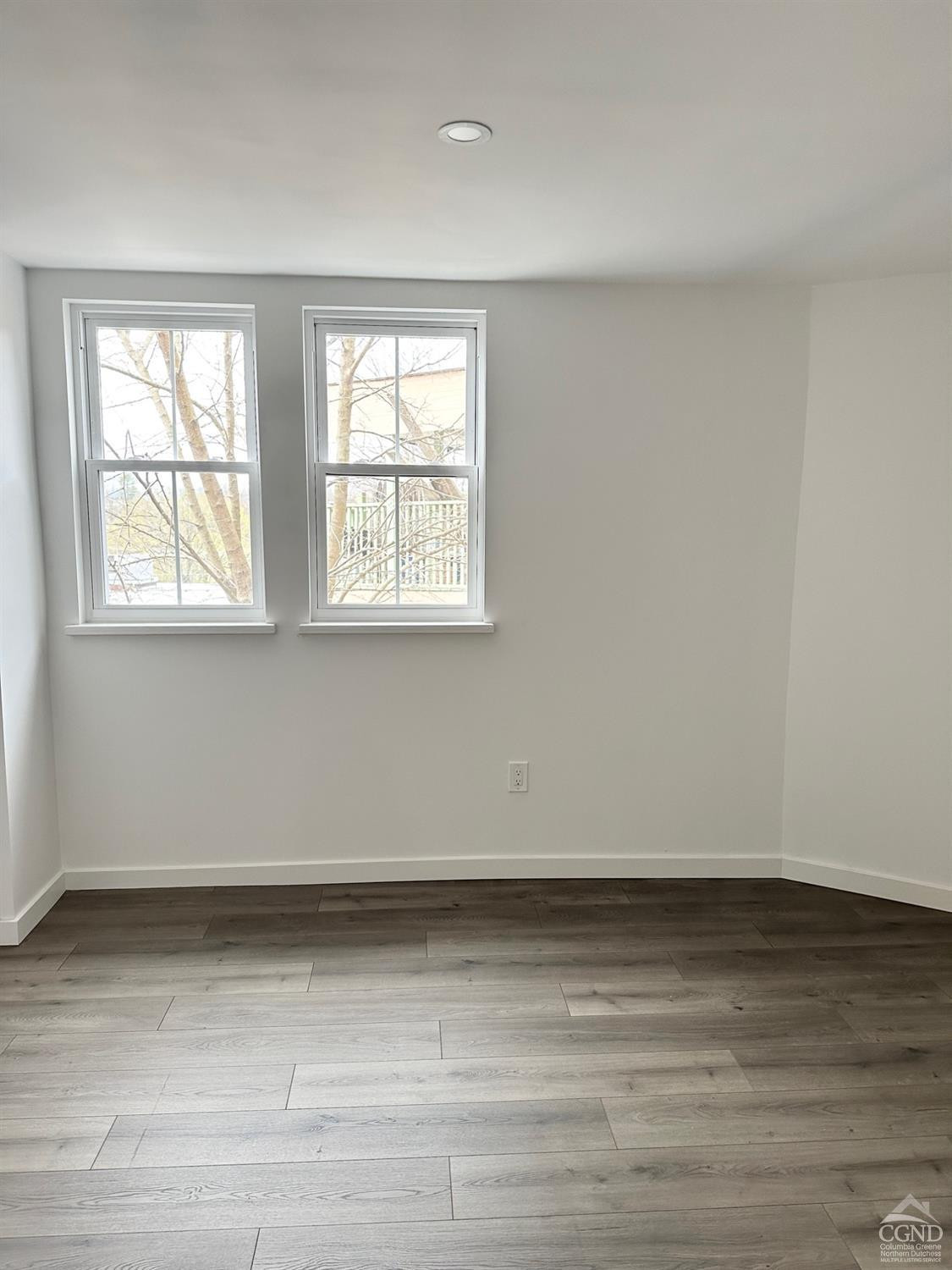 473 Main Street, Unit 1 Catskill, NY 12414 - Photo 11 of 11 an empty room with wooden floor and windows