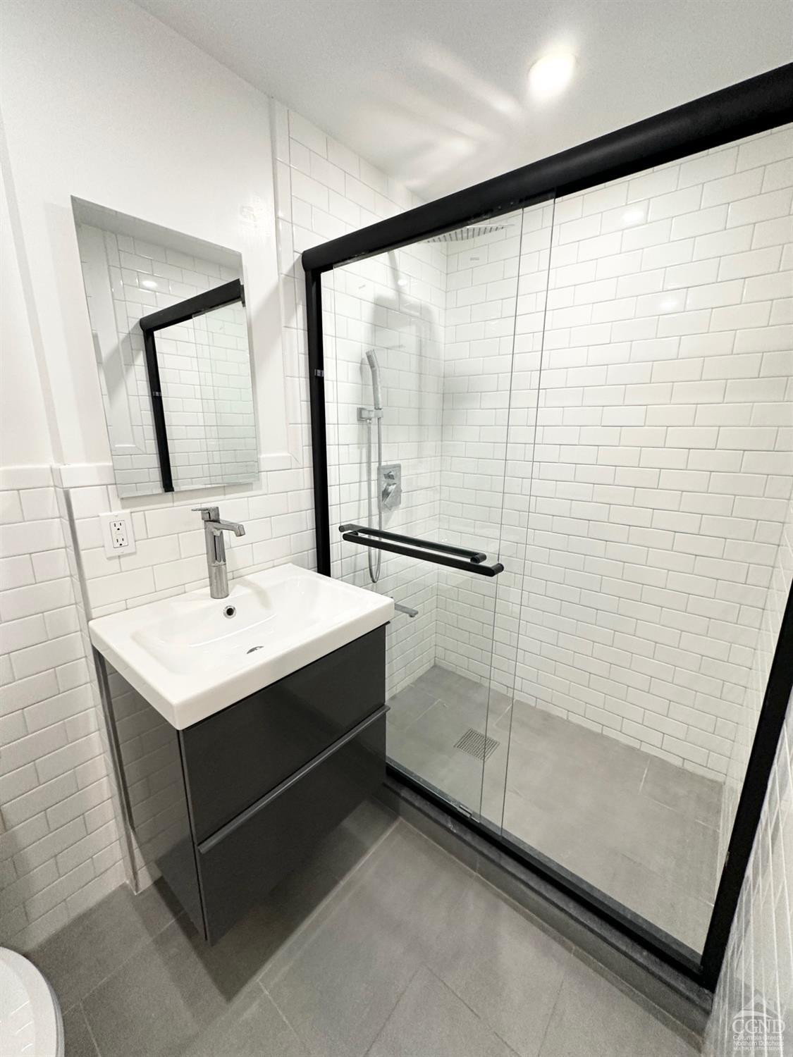 473 Main Street, Unit 1 Catskill, NY 12414 - Photo 9 of 11 a bathroom with a sink toilet and mirror