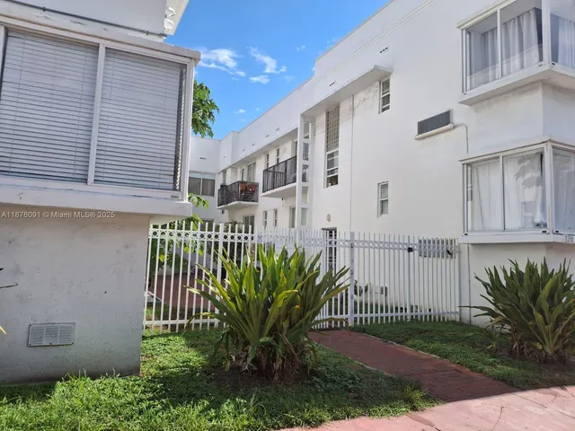 a view of a house with a small yard and plants