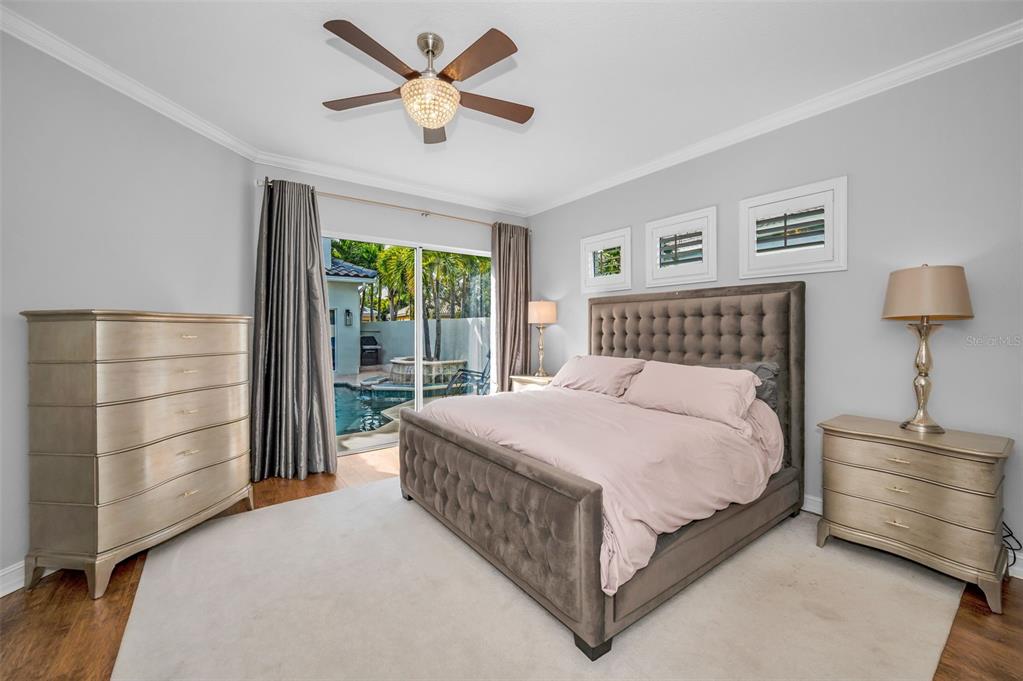 9952 Sago Point Drive Largo, FL 33777 - Photo 19 of 44 a bedroom with a bed chandelier and a window