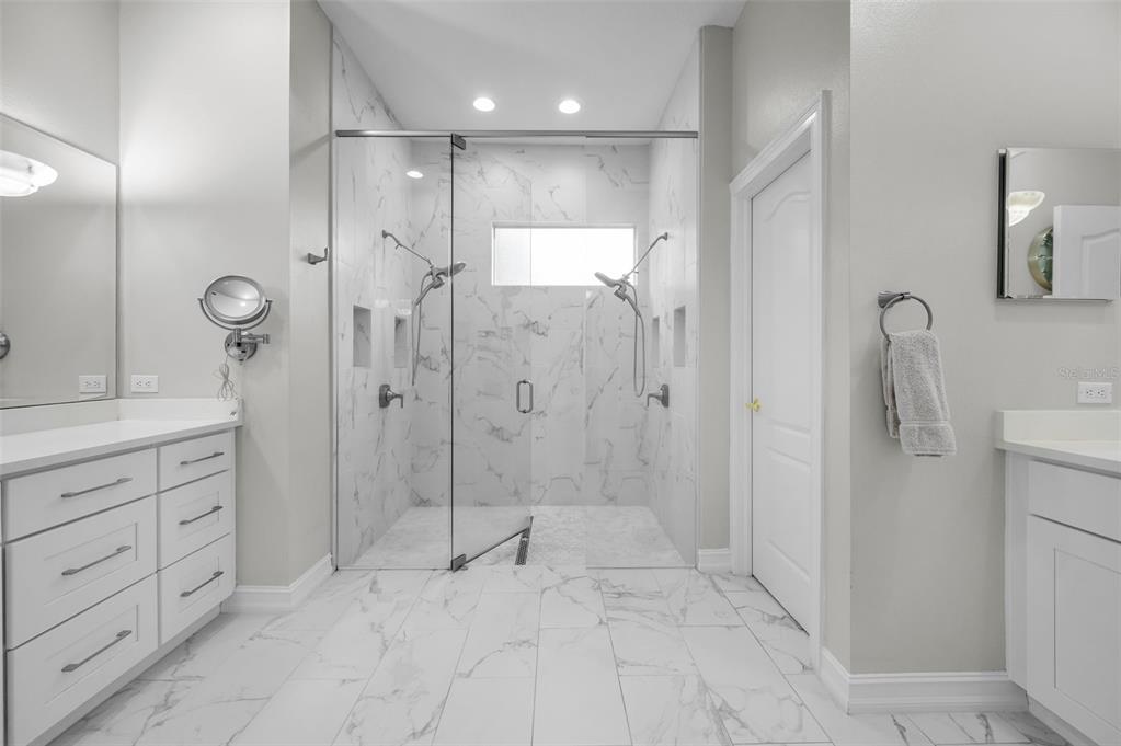 9952 Sago Point Drive Largo, FL 33777 - Photo 21 of 44 a bathroom with a shower sink and mirror