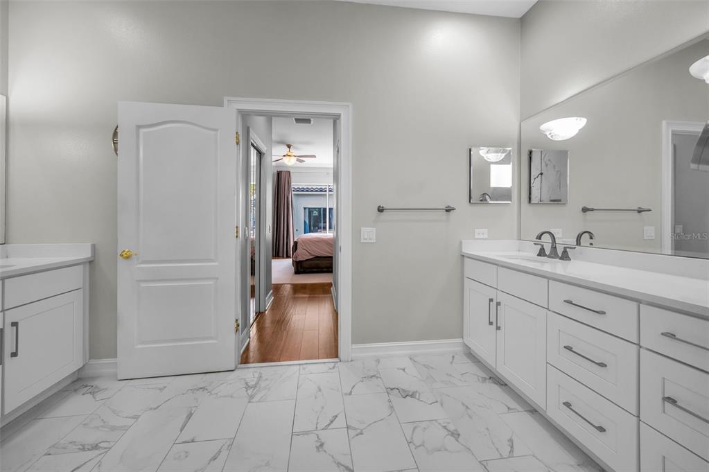 9952 Sago Point Drive Largo, FL 33777 - Photo 22 of 44 a spacious bathroom with a shower sink and mirror