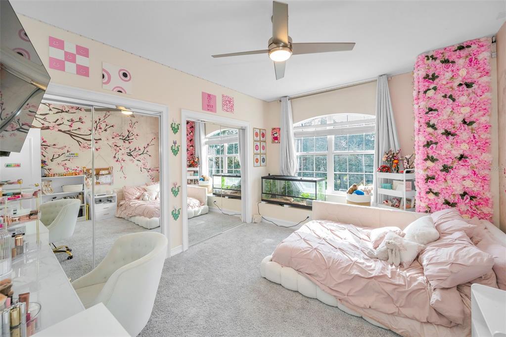 9952 Sago Point Drive Largo, FL 33777 - Photo 23 of 44 a spacious bedroom with a bed couch and a window