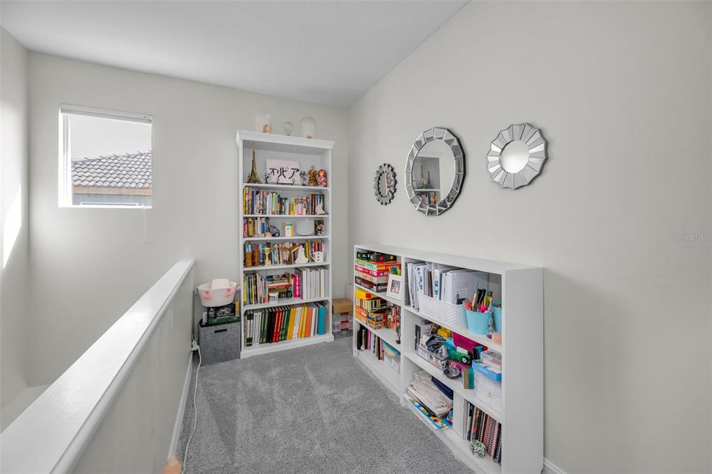 9952 Sago Point Drive Largo, FL 33777 - Photo 26 of 44 a view of a book shelf with lots of books