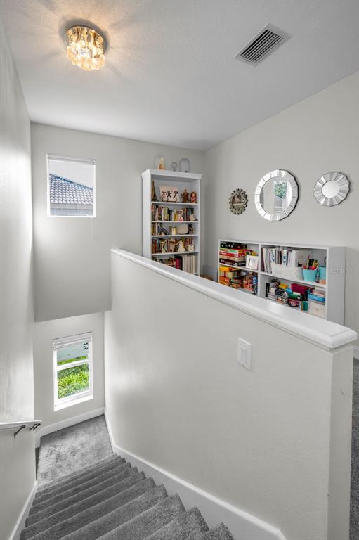 9952 Sago Point Drive Largo, FL 33777 - Photo 27 of 44 a living room with furniture and a book shelf
