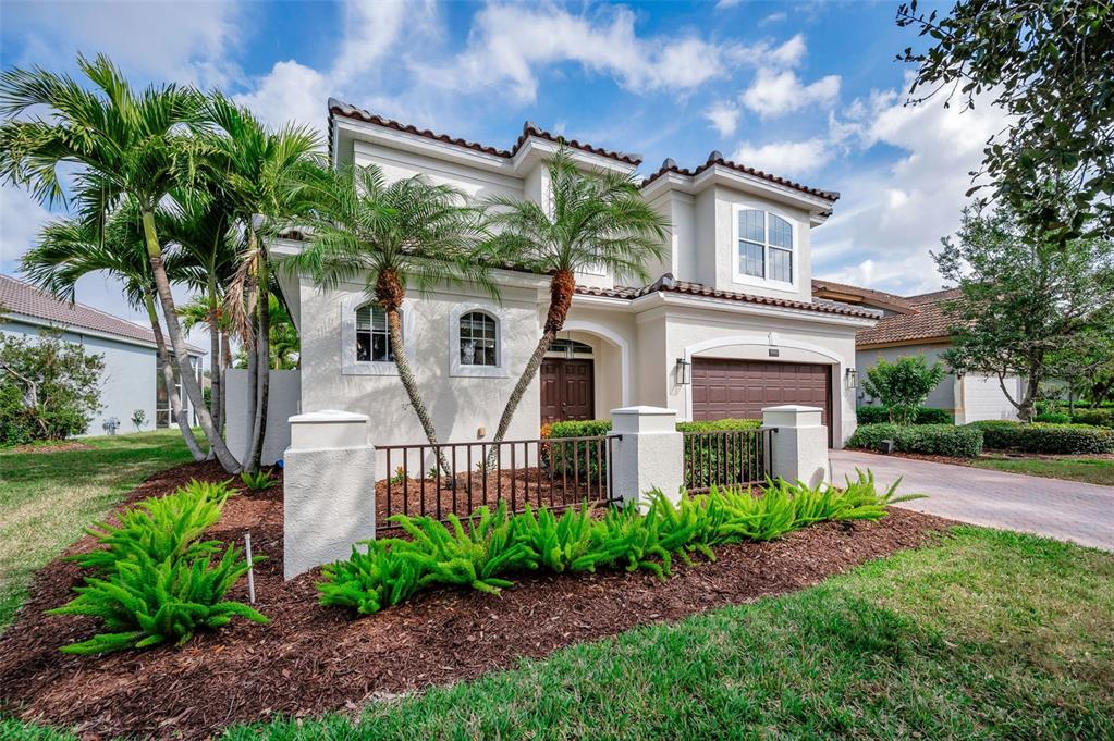 9952 Sago Point Drive Largo, FL 33777 - Photo 3 of 44 a front view of a house with garden