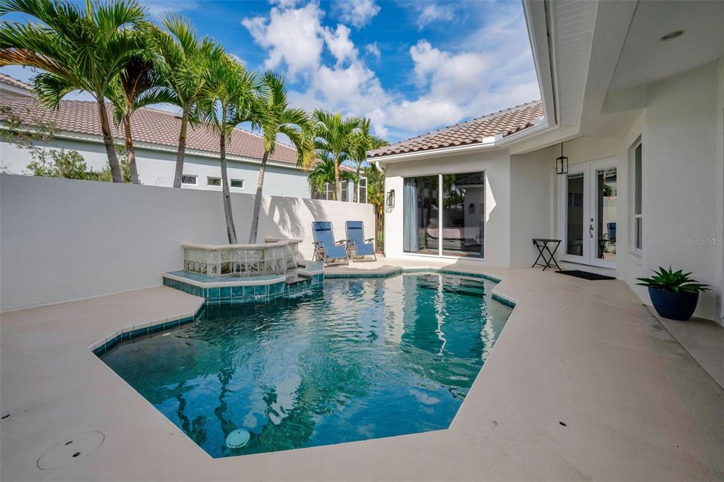 9952 Sago Point Drive Largo, FL 33777 - Photo 32 of 44 a view of a swimming pool with a patio