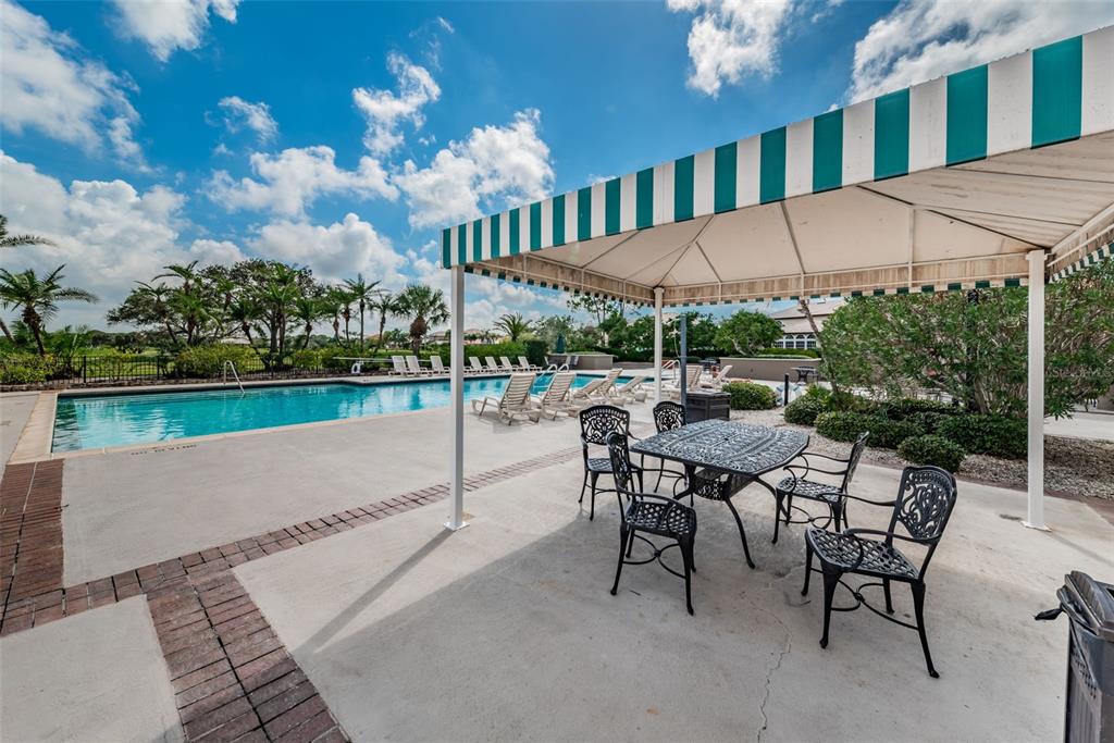 9952 Sago Point Drive Largo, FL 33777 - Photo 40 of 44 a view of a patio with table and chairs under an umbrella
