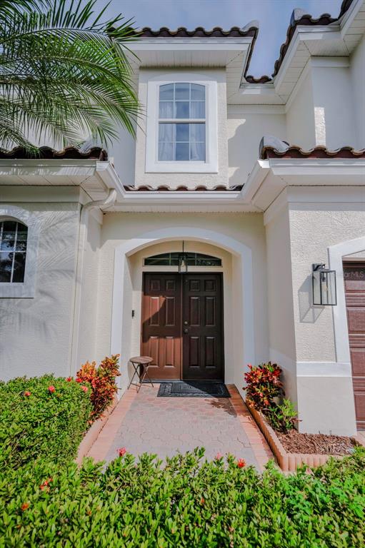 9952 Sago Point Drive Largo, FL 33777 - Photo 4 of 44 a front view of a house with a yard