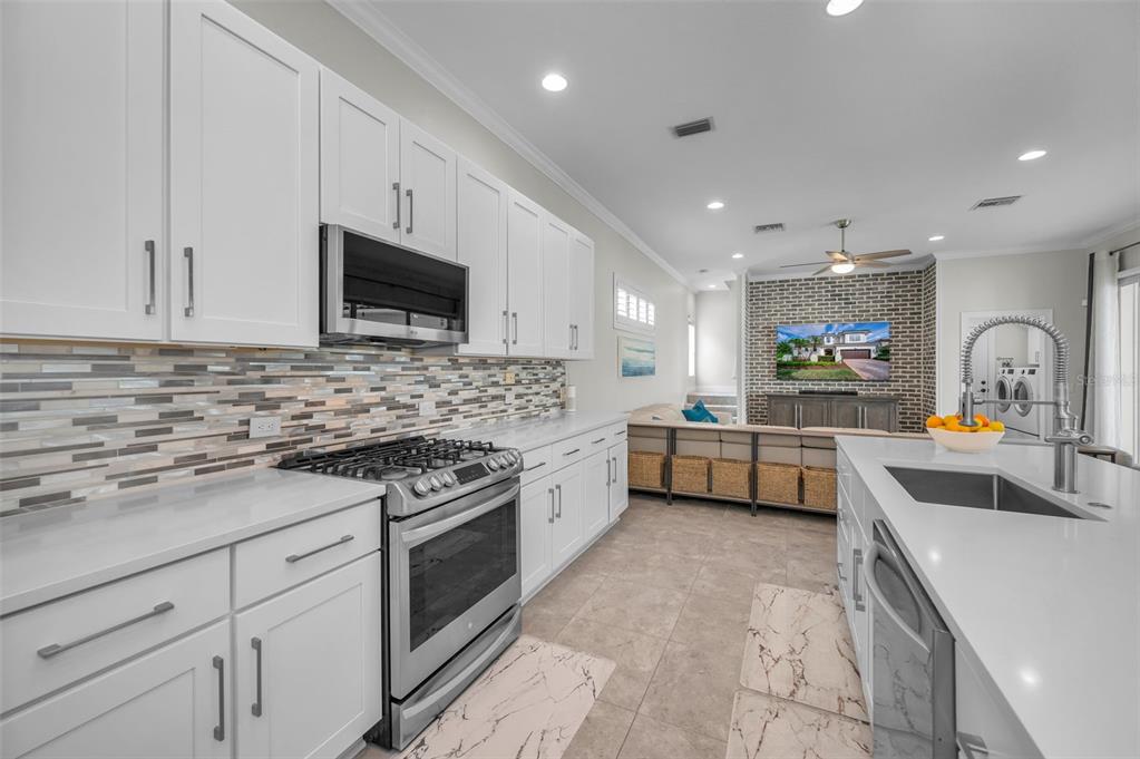 9952 Sago Point Drive Largo, FL 33777 - Photo 9 of 44 a kitchen with stainless steel appliances granite countertop a sink and cabinets