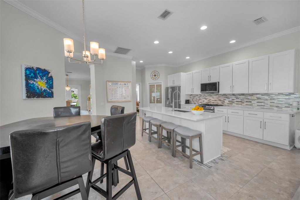 9952 Sago Point Drive Largo, FL 33777 - Photo 10 of 44 a kitchen with kitchen island granite countertop a sink cabinets and refrigerator