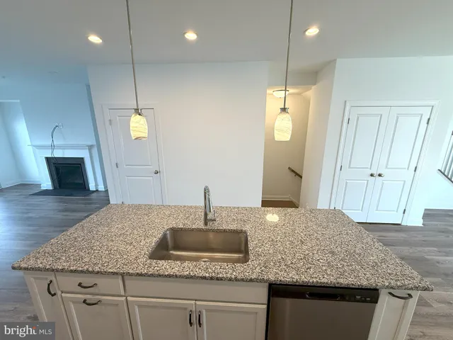 an empty room with windows and fireplace