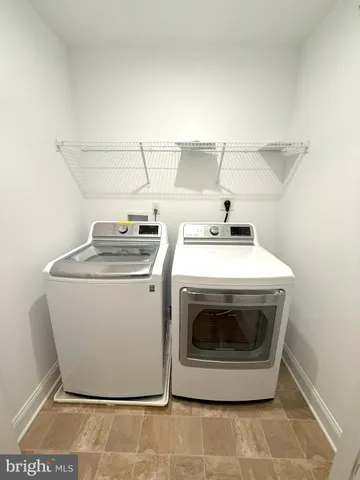 an empty room with a window and a ceiling fan