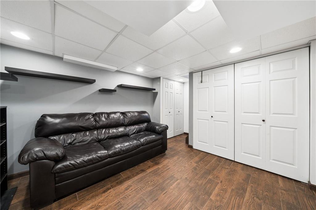 711 Jane Street Pittsburgh, PA 15239 - Photo 17 of 27 This versatile family room features modern drop ceiling panels and massive built-in closet storage.