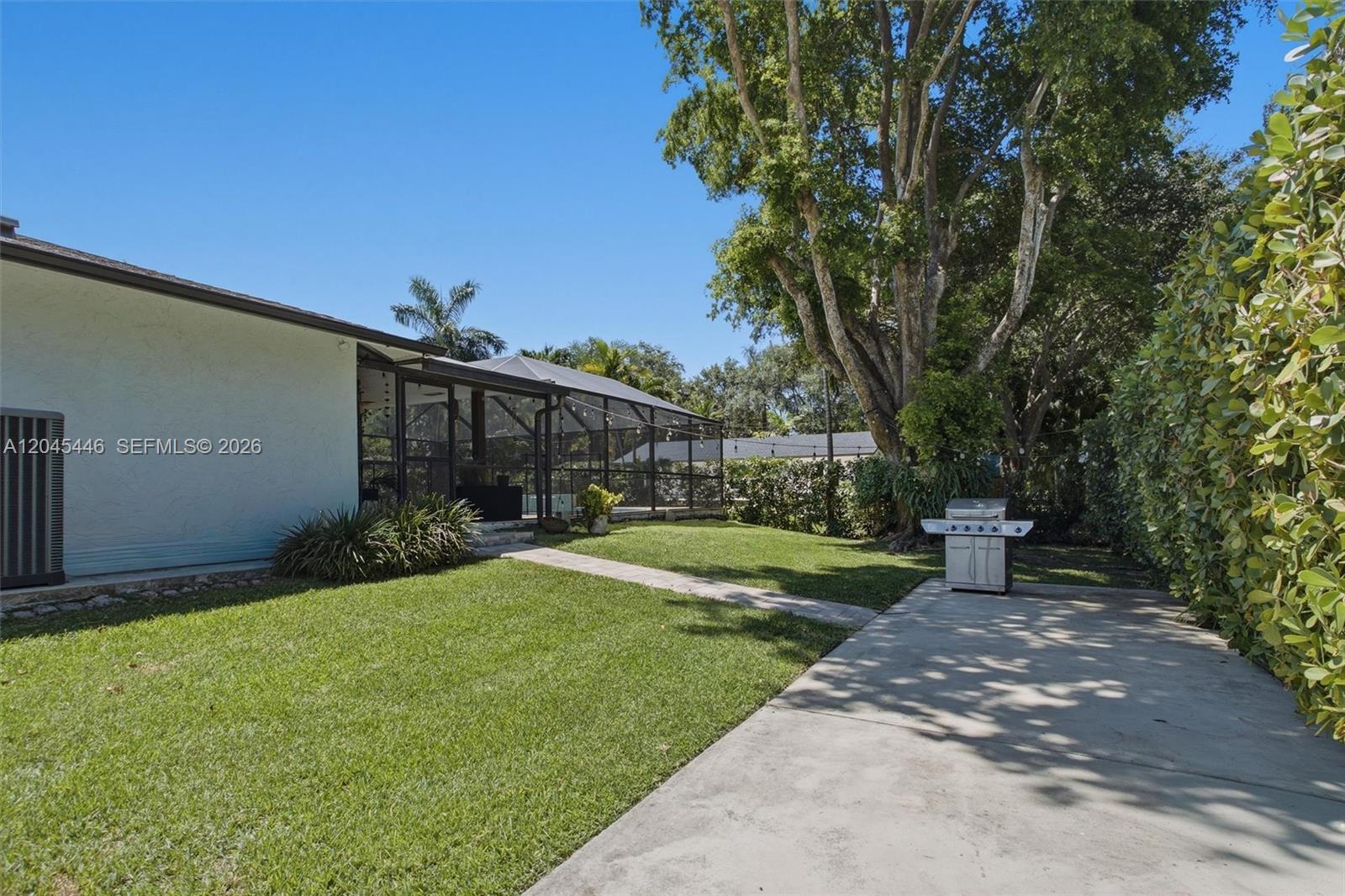 8440 Southwest 180th Street Palmetto Bay, FL 33157 - Photo 50 of 54 a view of a house with a yard and tree s