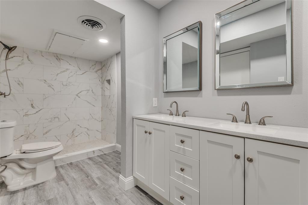 5033 Cedar Springs Road, Unit 103 Dallas, TX 75235 - Photo 9 of 12 a bathroom with a double vanity sink toilet and shower