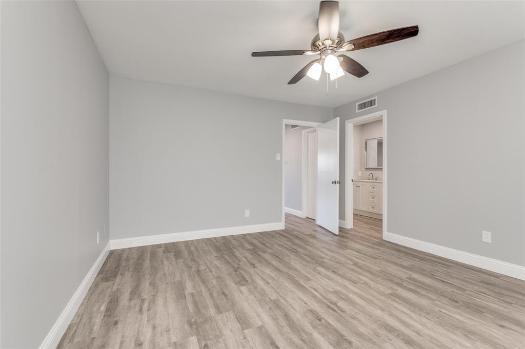 5033 Cedar Springs Road, Unit 103 Dallas, TX 75235 - Photo 7 of 12 a view of an empty room with wooden floor