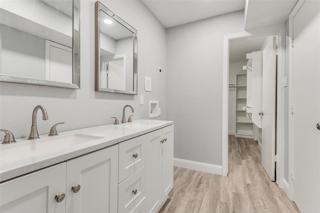5033 Cedar Springs Road, Unit 103 Dallas, TX 75235 - Photo 8 of 12 a bathroom with a double vanity sink and a mirror