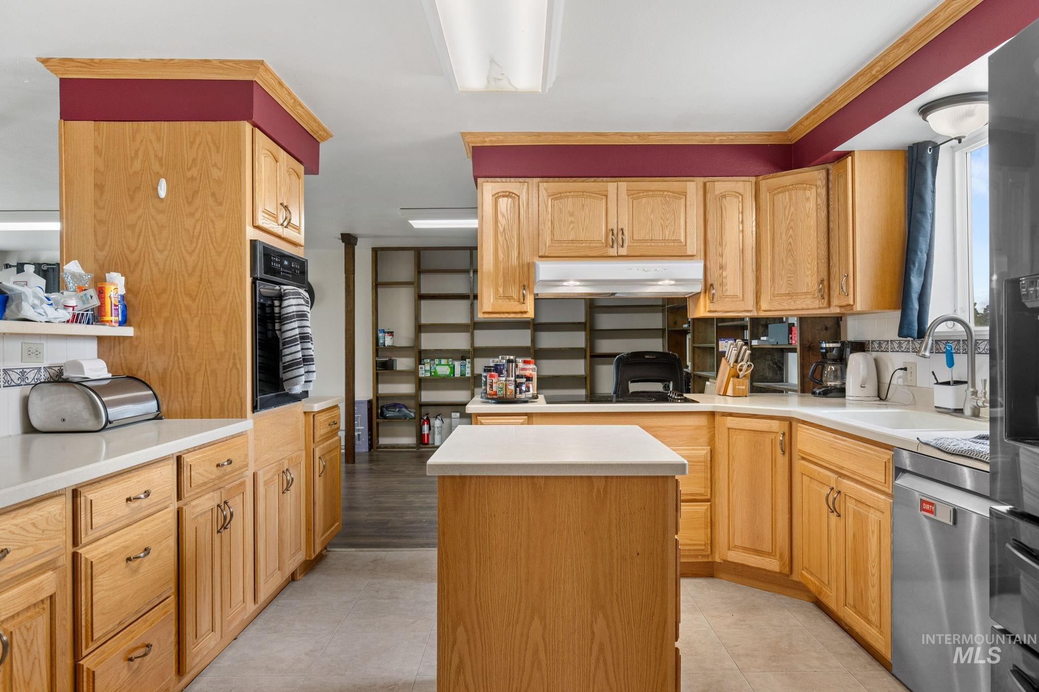 18338 Pride Lane Caldwell, ID 83607 - Photo 12 of 50 Kitchen featuring light wood cabinetry, white countertops, stainless steel appliances, and a central island