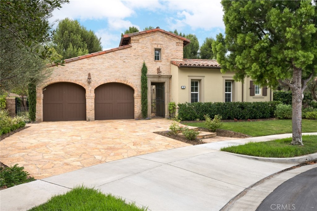 a view of a white house with a yard and large tree