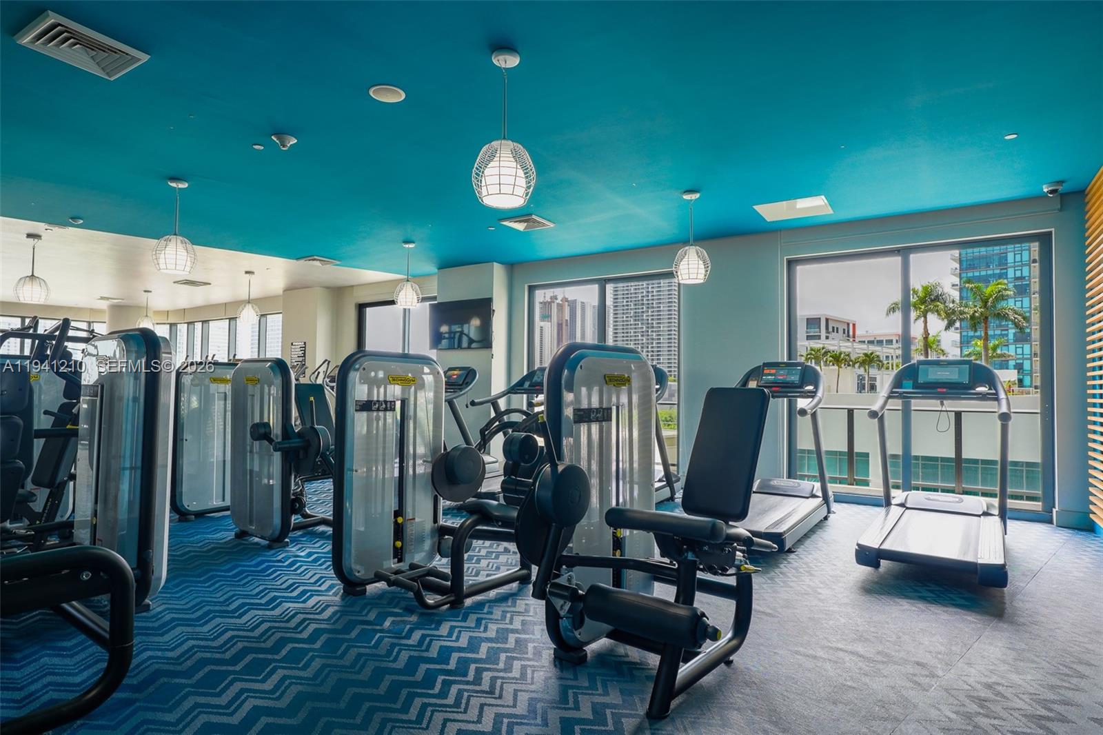 121 Northeast 34th Street, Unit 2711 Miami, FL 33137 - Photo 16 of 42 a view of a room with gym equipment