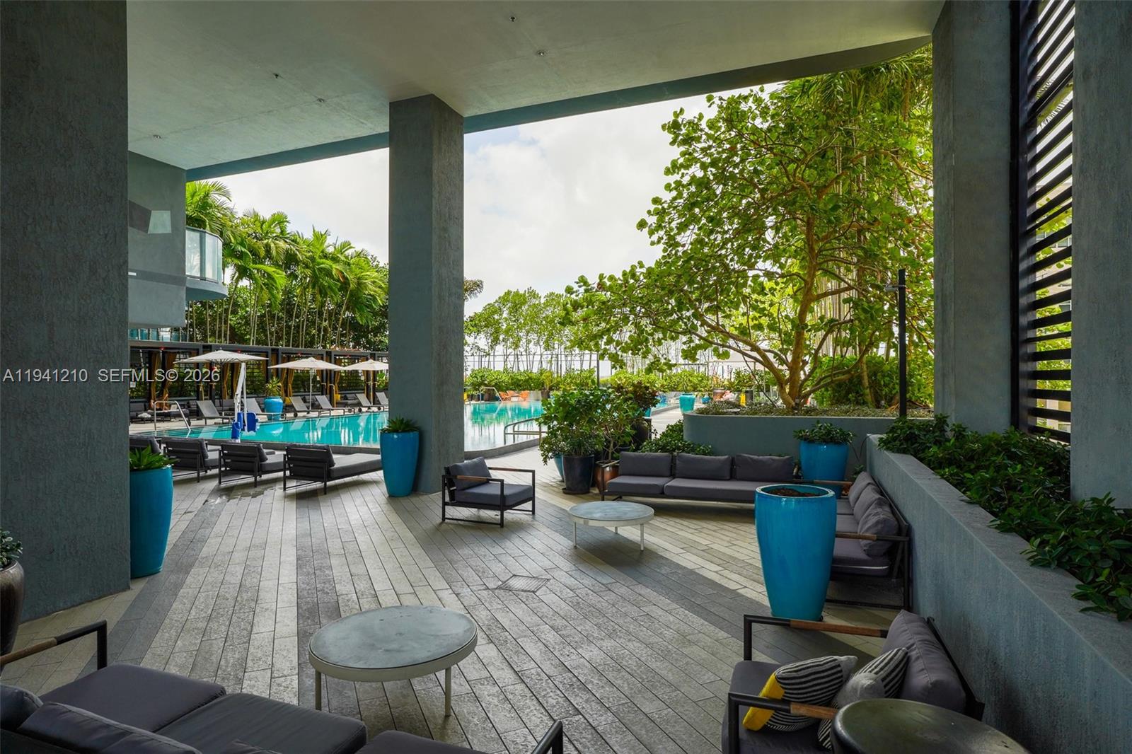 121 Northeast 34th Street, Unit 2711 Miami, FL 33137 - Photo 29 of 42 a view of a porch with furniture and a yard