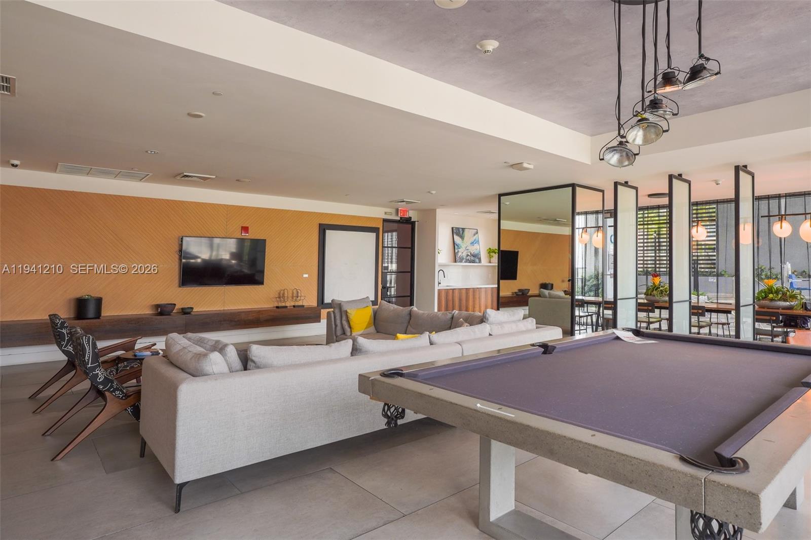 121 Northeast 34th Street, Unit 2711 Miami, FL 33137 - Photo 34 of 42 a outdoor space with furniture and a flat screen tv