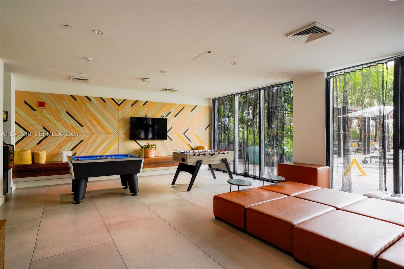 121 Northeast 34th Street, Unit 2711 Miami, FL 33137 - Photo 36 of 42 a living room with furniture a rug and white walls