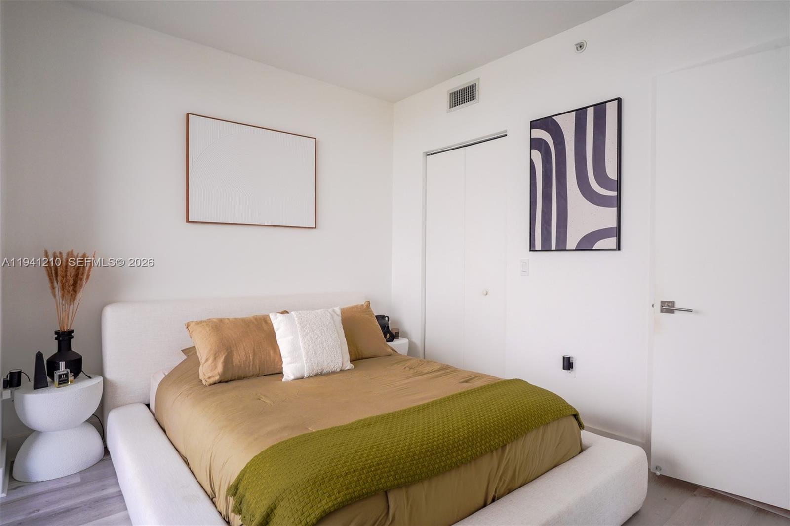 121 Northeast 34th Street, Unit 2711 Miami, FL 33137 - Photo 7 of 42 a bedroom with a bed and painting on the wall