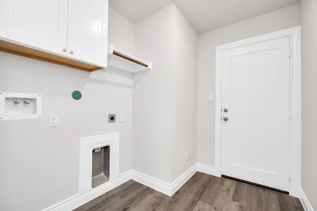 an empty room with closet and windows