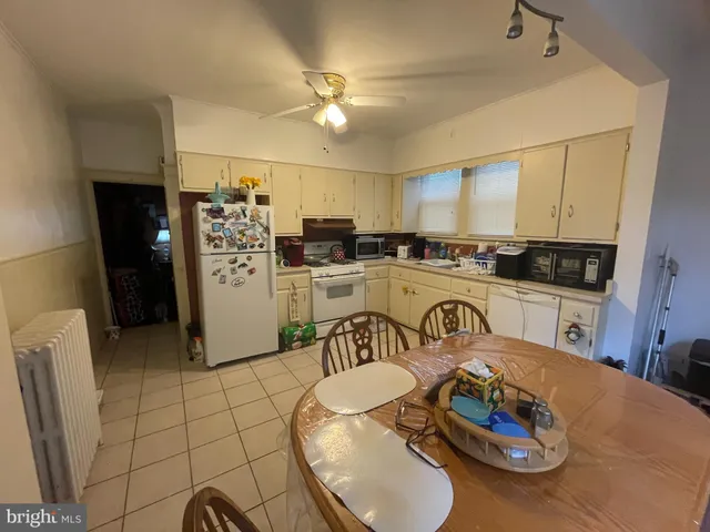 a kitchen with stainless steel appliances kitchen island granite countertop a sink and cabinets