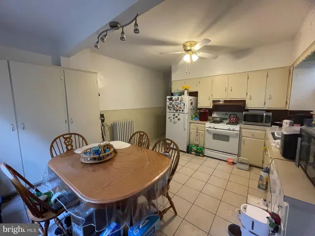 a kitchen with a sink a stove a kitchen island and chairs