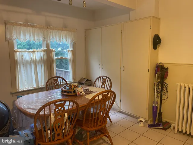 a view of a dining room with furniture and a window